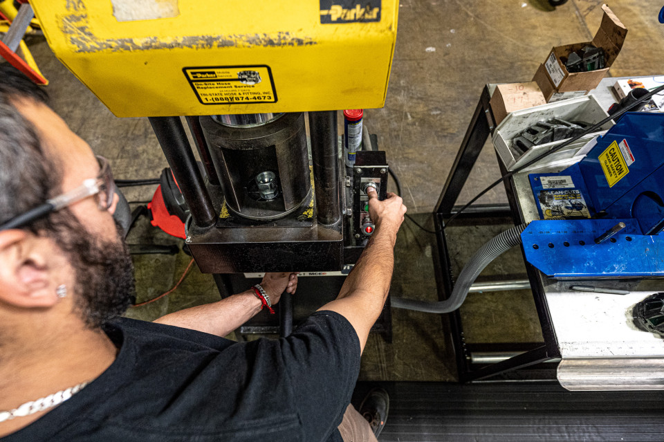 MCE employee using a Parkrimp II for a Parker hose. 